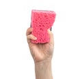 Hand without protective rubber glove using red kitchen sponge isolated on a white background Royalty Free Stock Photo
