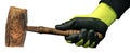 Hand with Protective Work Glove Holding an old Wooden Mallet or Hammer