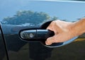 A hand pulling car door handle Royalty Free Stock Photo