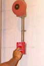 Hand pulling down the manual fire alarm station in case of fire emergency Royalty Free Stock Photo
