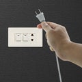 Hand pulling electrical plug Royalty Free Stock Photo