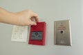 The hand is pulling fire alarm signal on the wall Royalty Free Stock Photo