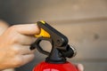 Hand pulling pin of fire extinguisher. Safety concept Royalty Free Stock Photo