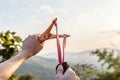 Hand pulling slingshot to shoot tree seed into forest. Royalty Free Stock Photo
