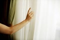 Hand pulling a window curtain Royalty Free Stock Photo