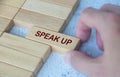 Hand pulling wooden block with text SPEAK UP. Courage concept Royalty Free Stock Photo