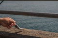 Hand pulls on the fishing line on which the fish is caught. Fisherman fishing perch in the lake Geneva. Perca fluviatilis. Common