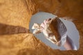 A hand pulls out a paper-wrapped lunch in a paper bag. A mature man`s hand holds the snack over the open brown bag.  Shot from th Royalty Free Stock Photo