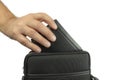 The hand pulls out, puts the wallet out of the bag. On white background. Royalty Free Stock Photo