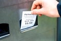 Hand pulls a ticket from a parking ticket machine Royalty Free Stock Photo