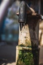 Hand pump to pull under ground water in india. Using Manual Water Pump on street. Water leaking from hand water pump in india. Royalty Free Stock Photo