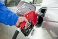 Hand Pumping Gasoline From Red Fuel Pump Nozzle Royalty Free Stock Photo