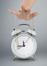 Hand puppeteer manipulating clock, time management concept Royalty Free Stock Photo