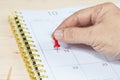 Hand push a pin mark on calendar Royalty Free Stock Photo