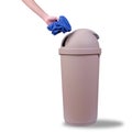 Hand push a trash into Big brown trashcan or waste bin on white Royalty Free Stock Photo