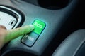 Hand pushing button in eco mode, Energy saving button ECO is working while driving energy-saving driving mode Royalty Free Stock Photo