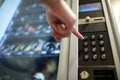 Hand pushing button on vending machine keyboard Royalty Free Stock Photo