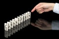 Hand pushing dominoes counters on black Royalty Free Stock Photo