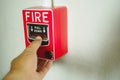 Hand pushing down the fire alarm button In the event of an emergency, the alarm must be triggered Royalty Free Stock Photo