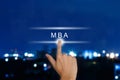 hand pushing The Master of Business Administration (MBA or M.B.A.) button on touch screen