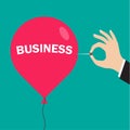 Hand pushing needle to pop. Business balloon