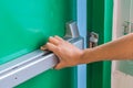 Hand is pushing/opening the emergency fire exit door Royalty Free Stock Photo