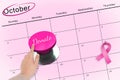 Hand pushing pink button for breast cancer awareness Royalty Free Stock Photo