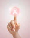 Hand pushing pink ribbon button Royalty Free Stock Photo