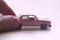 Hand pushing a pink toy car Royalty Free Stock Photo