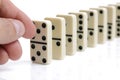 Hand pushing white dominoes