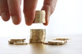 Hand put coin to money stack on white background. Close-up of hand putting a coin to stack of coins. Business finance and money Royalty Free Stock Photo