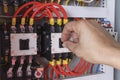 Hand put on contactors of machine control. Royalty Free Stock Photo