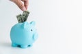 Hand put dollar money in a piggy bank with saving money is an investment for the future.. Royalty Free Stock Photo
