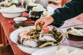 Hand while put food offerings in a Buddhist monk`s alms bowl.Sticky rice in alms bowl for buddhist monks Powder and sweet Coconut