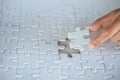 Hand put the last piece of jigsaw puzzle to complete the mission, Business solutions, success and strategy concept Royalty Free Stock Photo