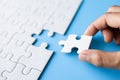 Hand put the last piece of jigsaw puzzle to complete the mission, Business solutions, success and strategy concept Royalty Free Stock Photo