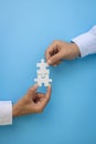 Hand put the last piece of jigsaw puzzle to complete the mission. Concept of connecting jigsaw pieces, problem solving, teamwork Royalty Free Stock Photo