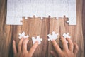 Hand put the last piece of jigsaw puzzle to complete the mission. Concept of connecting jigsaw pieces, problem solving, teamwork Royalty Free Stock Photo
