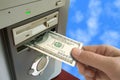 Hand put money to computer Royalty Free Stock Photo