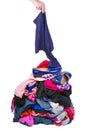 Hand put one item to pile of old used clothes isolated on white Royalty Free Stock Photo