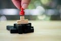Hand put a red chess pawn on wooden puzzle Royalty Free Stock Photo