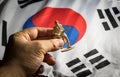 Hand put soldier toy to Korea flag. Royalty Free Stock Photo