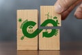 Hand put wooden cube symbol of infinite energy. Circular economy concept, recycle, environment, reuse, manufacturing, waste,