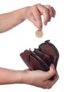 Hand puts a coin in the purse Royalty Free Stock Photo