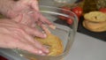 hand puts one frisa tipical apulian dish in water to moisten before being eaten