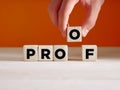 Hand puts the wooden cube with the word proof. To find a proof, evidence, verifying or proving something Royalty Free Stock Photo