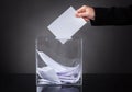 Hand putting ballot in box