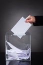 Hand putting ballot in box