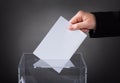 Hand putting ballot in box