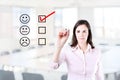 Hand putting check mark with red marker on customer service evaluation form. Office background. Royalty Free Stock Photo